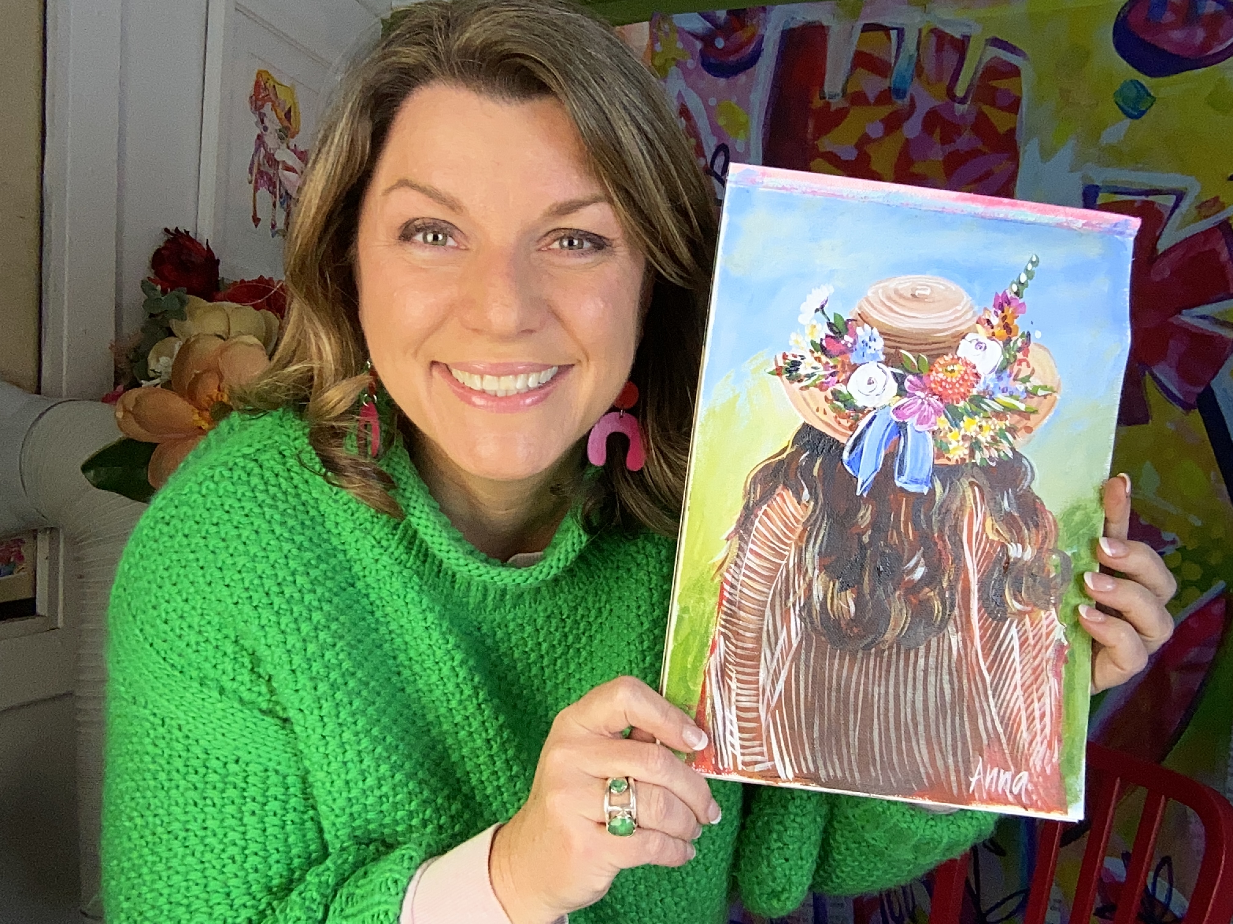Anna holding 'The Flower Hat' painting